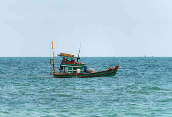 Fototapeta premium A fishing boat under the flag of Vietnam sails across the sea to the fishing spot