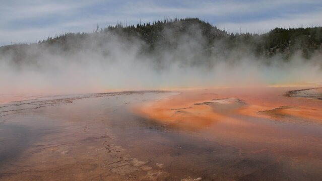 A large orange brown color geothermal spring in Wyoming
