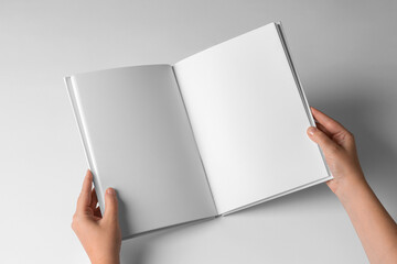 open Empty Book Template on White Background, hands Open book with blank pages. Mock up for design