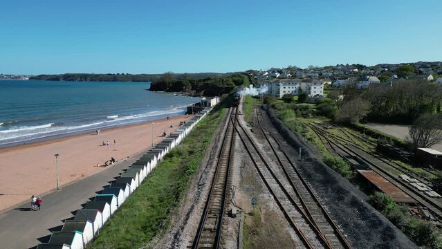 Goodrington Sands, South Devon, England: DRONE VIEWS: A steam train on route to Paignton on the Torbay Steam Railway line. The steam trains are a major tourist attraction for UK holidaymakers (Clip 2)