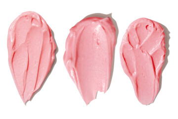 Pink smears of cream on empty background