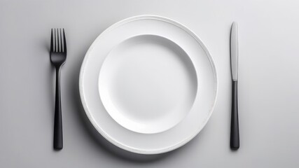 Empty round white plate with fork, knife on a white isolated background. Top view, Place for text.