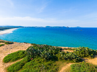 Aerial view of Bai Xep beach in Phu Yen province, Vietnam. Tropical coast from cliff above. Vietnam travel destination, golden sand beach waving sea rock boulders.