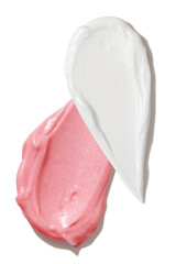 Pink and white cream smears on empty background