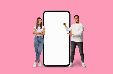 Young man and woman presenting smartphone screen