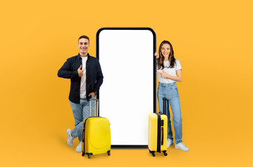 Couple standing beside gigantic phone, travel together