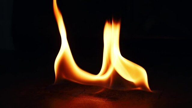 Fire Flames Igniting And Burning. Real flames ignite on a black background. Closeup of flames burning slow motion effect background footage motion graphics.