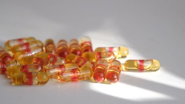 Pile of capsules Omega 3 on white background. Fish and red krill oil soft gel capsules 
