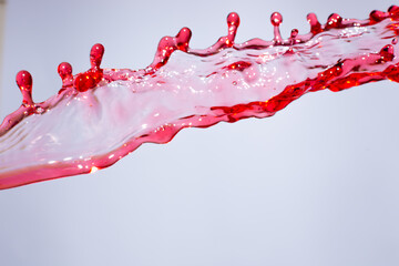 Splashes of red wine on white background, abstraction