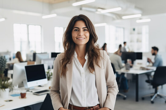 Candid portrait of 30 year old woman, ceo of successful startup company, in the office at work