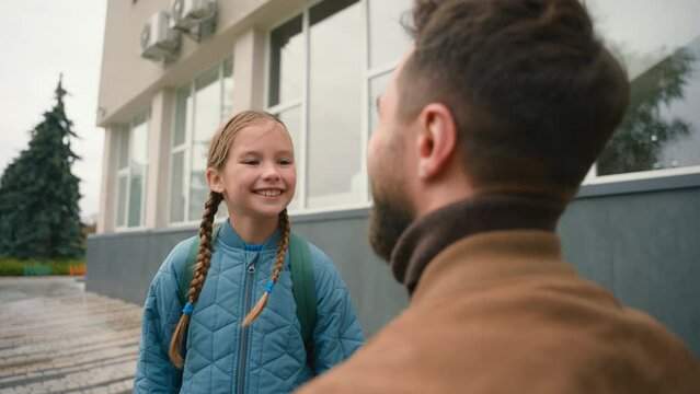 Father and daughter primary school farewell touch nose cute family joy happiness parenthood man girl schoolgirl study lessons gesture outside city kid child education pupil relations bond protecting