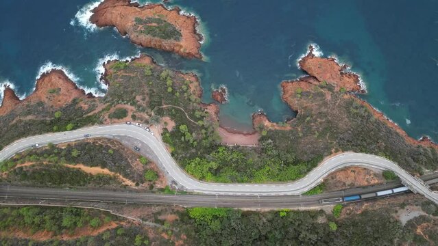 Aerial view of the Massif de L'Esterel and a beautiful winding road over the cliffs falling into the Mediterranean Sea. French Riviera. Cote d'Azur