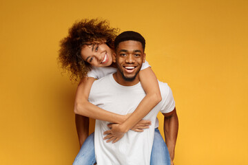 African-american couple having fun on orange background
