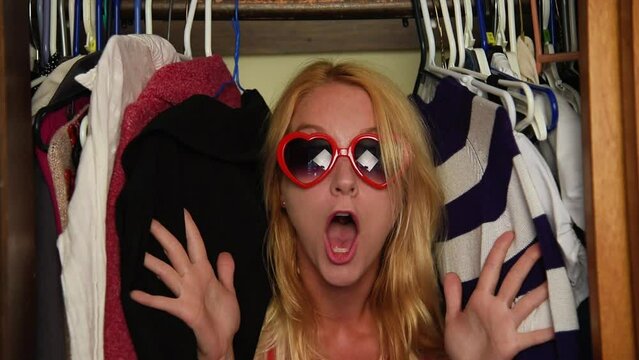 A little girl is wearing a pilot hat playing with an airplane toy pretending to fly against a brick wall for a childhood imagination or playing concept.