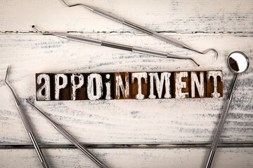 APPOINTMENT. Doctor or laboratory instruments on wood texture background - 790980374