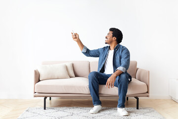Engaged Black Guy Pointing at Something in his Home