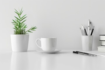 Minimalist white desk with potted plant, coffee cup, and office supplies for home office