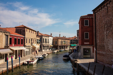 Panoramic view of small water channel on Murano island in city of Venice, Veneto, Italy, Europe. Venetian architectural landmarks and old houses facades along the man made water traffic corridor - obrazy, fototapety, plakaty