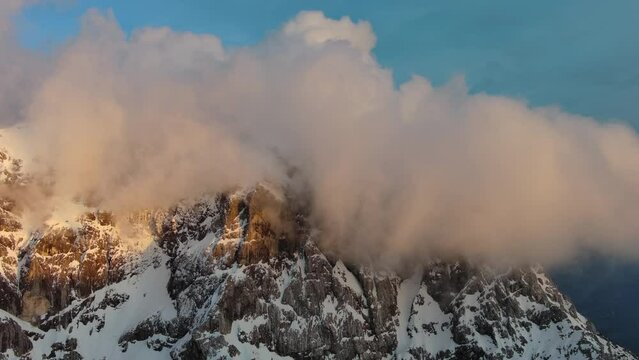 Aerial view of high mountains and clouds in the Triglav National Park at sunset, Julian Alps, Slovenia, 4k