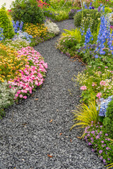 rock path leading through a flower garden