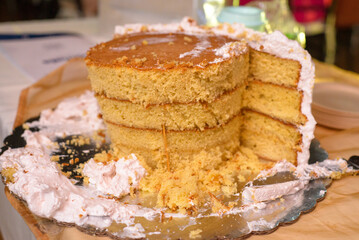 Remains of a cake on the table. End of the party.
