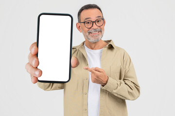Elderly man showing a smartphone screen on white background