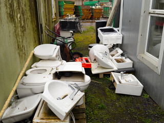 Old basins and toilet pans at scrap compound