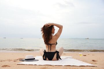 Back view of young woman with swiming suit walk relax on tropical beach, happy summer vacation