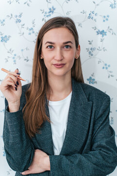 Portrait of professional female beautician posing and confidently looking at camera.