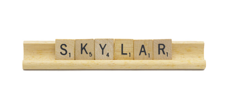 Miami, FL 4-18-24 popular baby girl first name of SKYLAR made with square wooden tile English alphabet letters with natural color and grain on a wood rack holder isolated on white background