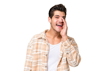 Young handsome caucasian man over isolated background shouting with mouth wide open