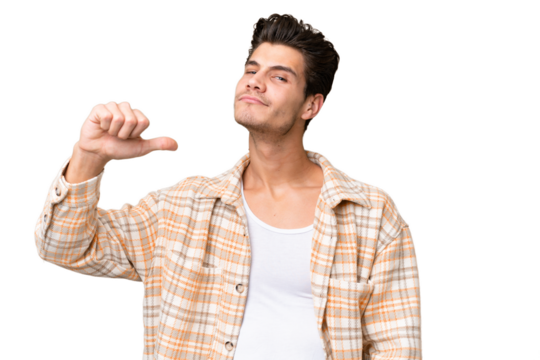 Young handsome caucasian man over isolated background proud and self-satisfied