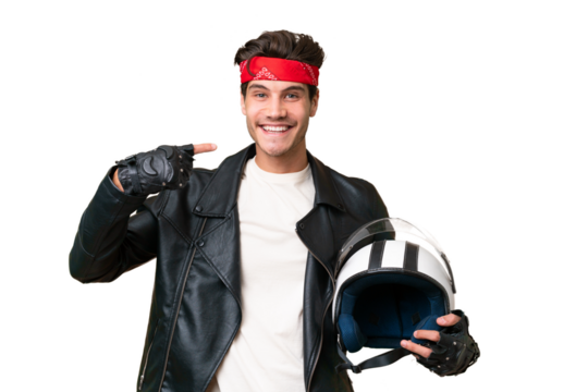 Young caucasian man with a motorcycle helmet over isolated background giving a thumbs up gesture