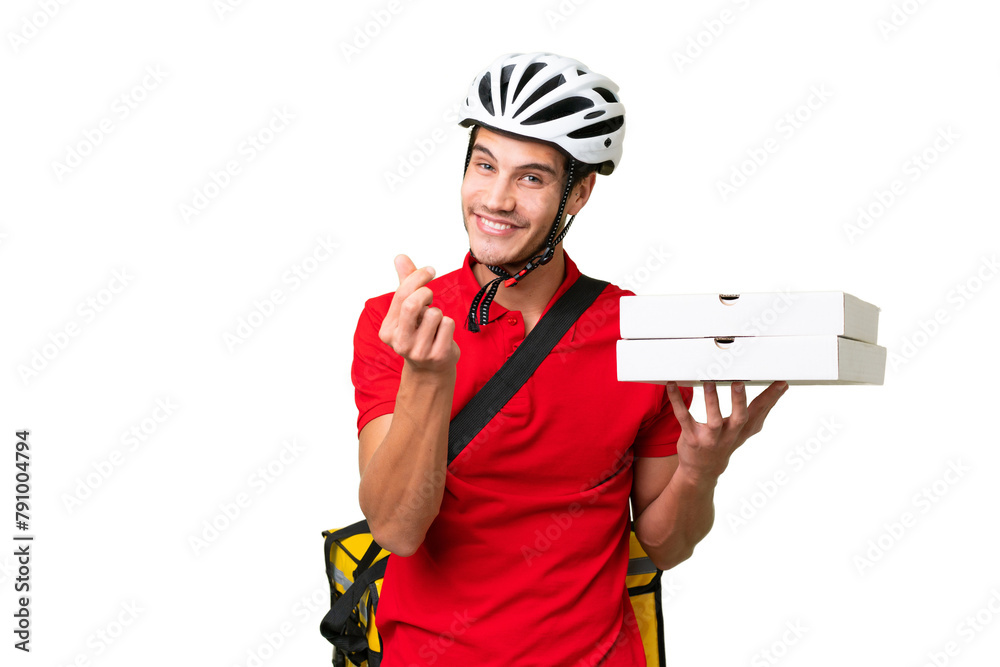 Wall mural Pizza delivery man with work uniform picking up pizza boxes over isolated background making money gesture