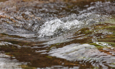 Close up of the surface of a spring rushing torrent. Concept of vitality and energy.