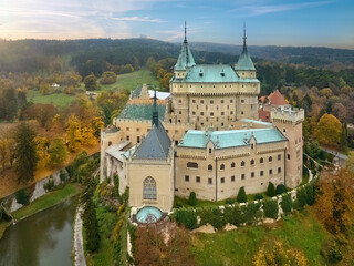 Bojnice Castle, Slovakia. Aerial view of neo-gothic romantic castle in colorful autumn garden and...