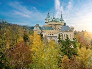 Panoramic View of romantic Bojnice Castle within Vivid Fall Colors garden, blue sky - Ideal for...