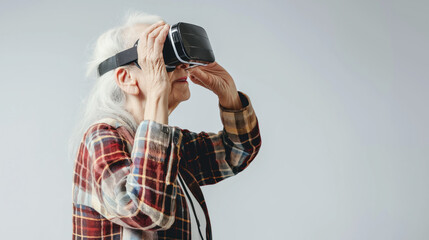 Old lady with virtual reality headset, studio shot on gray background
