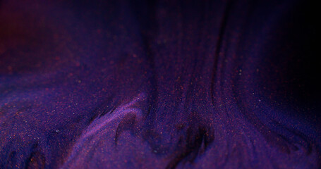 Liquid glitter. Sparkling paint wave. Defocused purple black color shimmering sand particles ink...