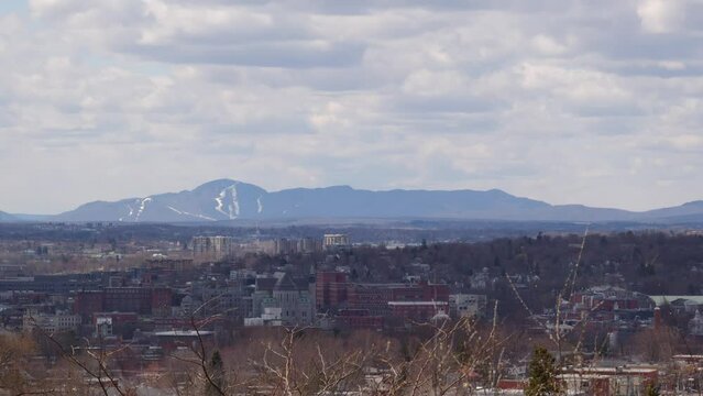 Eastern Townships small city Sherbrooke downtown mountain cloudy sky and buildings in Quebec Canada Estrie time lapse