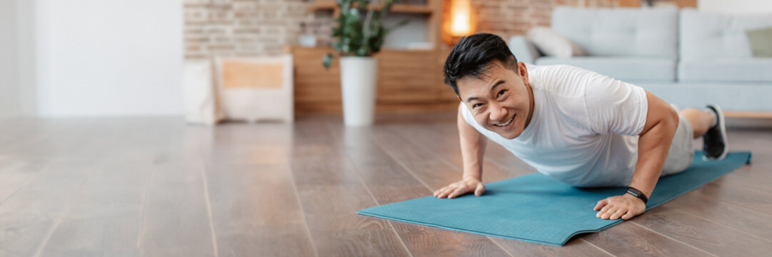 Strong asian mature man making strength workout - Powered by Adobe
