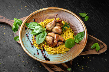 Quail with homemade noodles. Menu for a pub on a dark background. Colorful juicy food photography.