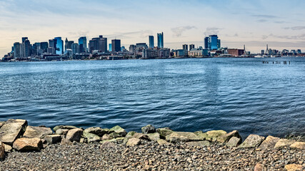 Boston Skyline with rock beach in foreground
