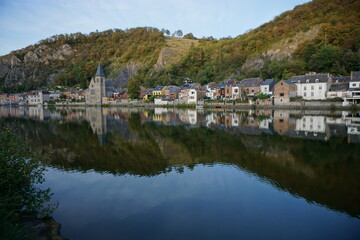 Fototapeta na wymiar view of the town of Dinant in Belgium on the Meuse river with mirror reflection 