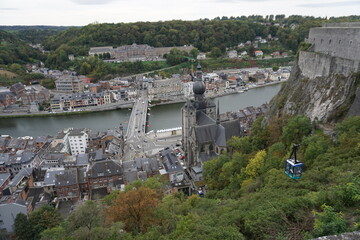 view of the town of Dinant in Belgium on the Meuse river from the old stone fort above  with the gondola