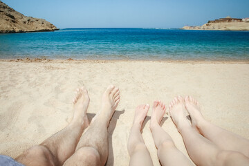 Stylish beautiful legs on the sea shore background