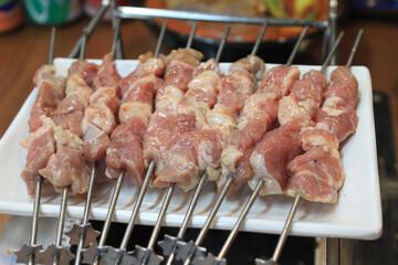 close up of skewers with raw meat