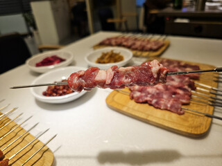 close up of skewers with grilled meat