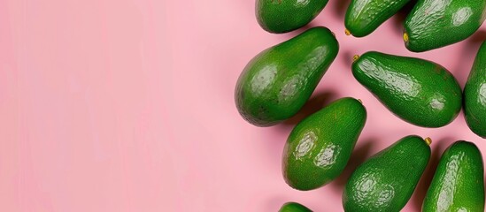 Green avocados arranged in a minimal flat lay style on a pink background, a pop art design...