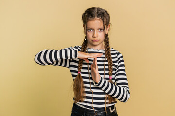 Tired serious upset young preteen child girl kid showing time out gesture, limit or stop sign, no...
